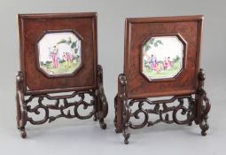 A pair of Chinese carved and pierced hardwood table screens, 19th century, inset with octagonal