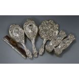 An Edwardian five piece embossed silver mounted dressing table set by Levi & Salaman and a similar