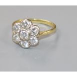 A modern 18ct gold and seven stone diamond flowerhead cluster ring, size P.