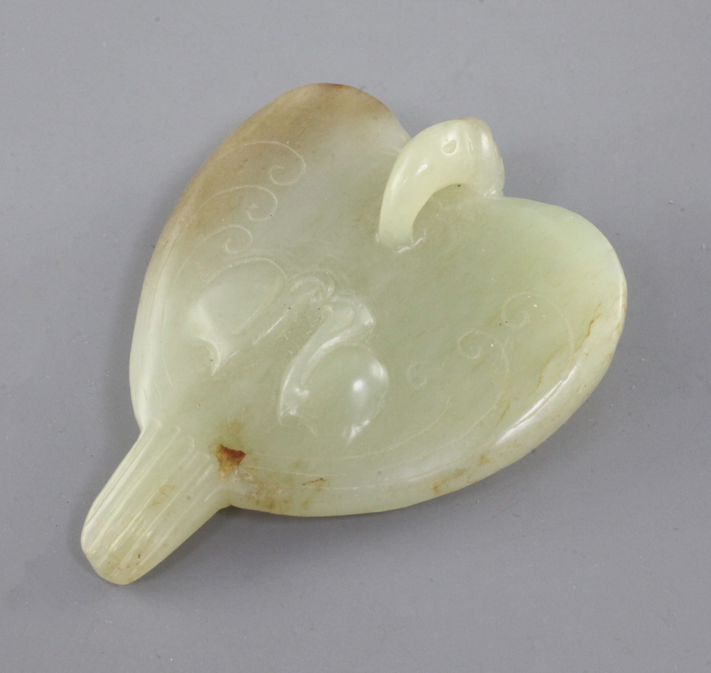 A Chinese yellow and russet jade carving of a falcon, Eastern Zhou dynasty or later, the stylised