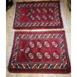 A pair of Afghan wool prayer rugs, red field with nine guls to the field 92 x 69cm