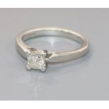 A platinum and solitaire princess cut diamond ring, size K.