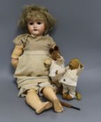 An early 20th century Bisque jointed doll with open mouth and sleeping eyes, and two small plush