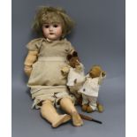 An early 20th century Bisque jointed doll with open mouth and sleeping eyes, and two small plush