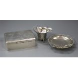 A silver helmet shaped cream jug, a silver mounted cigarette box and a silver bon-bon dish.