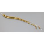 A yellow metal bead necklace (a.f.).