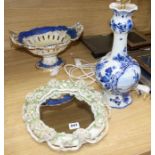 A Victorian floral encrusted wall mirror, a comport and a delft table lamp
