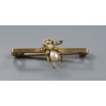 A late Victorian yellow metal and seed pearl set bug bar brooch, 4cm.