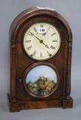 A 19th century walnut mantel clock, with painted glass panel and Roman dial Height 44cm