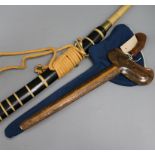 A Chinese Dao sword with rope-bound brass-ended grip and ebonised scabbard and a decorative Kris-