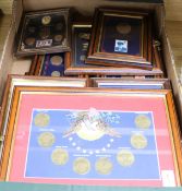 A collection of twenty-one framed coin, banknote, stamp and commemorative medal collections,