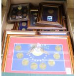 A collection of twenty-one framed coin, banknote, stamp and commemorative medal collections,