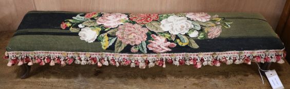 A Victorian needlework footstool W.90cm