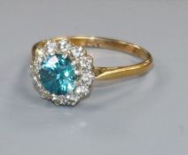 An 18ct gold, blue zircon and diamond cluster ring, size S.
