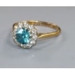 An 18ct gold, blue zircon and diamond cluster ring, size S.