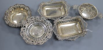 A pair of George V pierced silver bonbon dishes, two other pierced dishes and a pierced silver