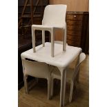 An Artemide Stadio 120 white plastic table and four chairs Table W.82cm