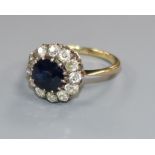 An 18ct gold, sapphire and diamond cluster ring, size J/K.