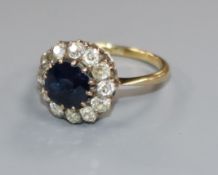 An 18ct gold, sapphire and diamond cluster ring, size J/K.