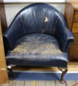 A pair of blue leather tub chairs