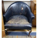 A pair of blue leather tub chairs