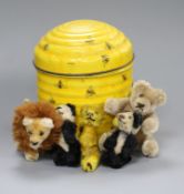 A quantity of small plush toy animals in a honey tin