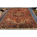 A Heriz red ground carpet 347 x 255cm