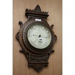 A late Victorian carved oak barometer W.35cm