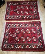 A pair of Afghan wool prayer rugs, red field with nine guls to the field 92 x 69cm