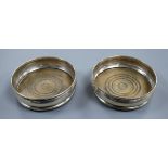 A pair of 1960's silver wine coasters with turned wooden bases, London, 1968/9, 13.2cm.