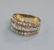 A yellow metal and three row diamond dress ring, size L.