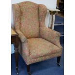 An Edwardian mahogany wing armchair