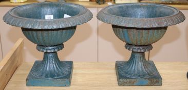 A pair of metal garden urns height 29cm diameter 32cm