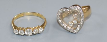 An 18ct gold and graduated five stone diamond ring and a 14ct gold and 'floating' diamond heart