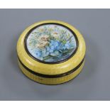 An early 20th century silver and enamel circular box and cover with central painted floral panel,