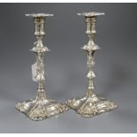 A pair of Edwardian George II style silver candlesticks (weighted), Thomas A. Scott, Sheffield 1902,