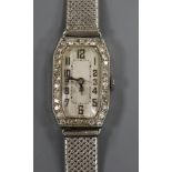 A lady's platinum and diamond set manual wind cocktail watch, on a 9ct white gold mesh bracelet.