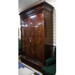 A Charles X flame mahogany armoire, with deep moulded cornice, fitted two doors now enclosing