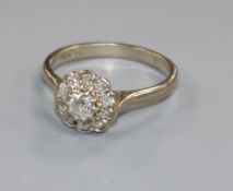 An 18ct white gold and diamond cluster ring, size M/N.