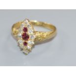 An early-mid 20th century 18ct gold, ruby and diamond marquise cluster ring, size M.