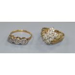 Two yellow metal and diamond set dress rings including illusion set three stone ring.