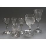 Three trumpet-shaped wine glasses, each with tear-drop stem and folded foot and three other glasses