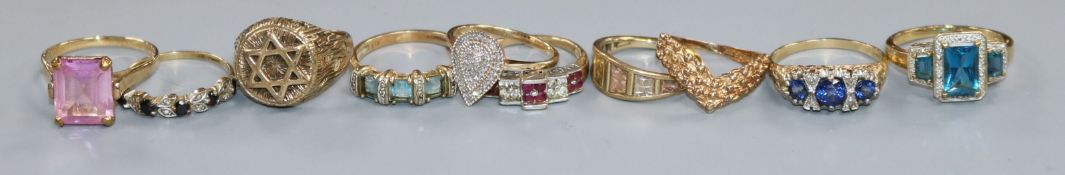 Ten assorted modern 9ct gold dress rings including a diamond set ring.