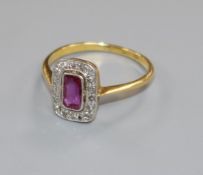 A 1920's/1930's 18ct gold and platinum ruby and diamond tablet ring, size M.