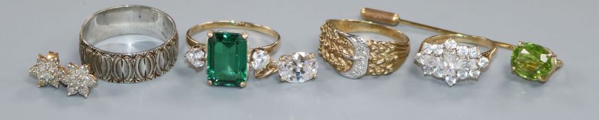 Four assorted 9ct gold rings including one set with diamonds, a pair of 9ct ear studs, 9ct pendant