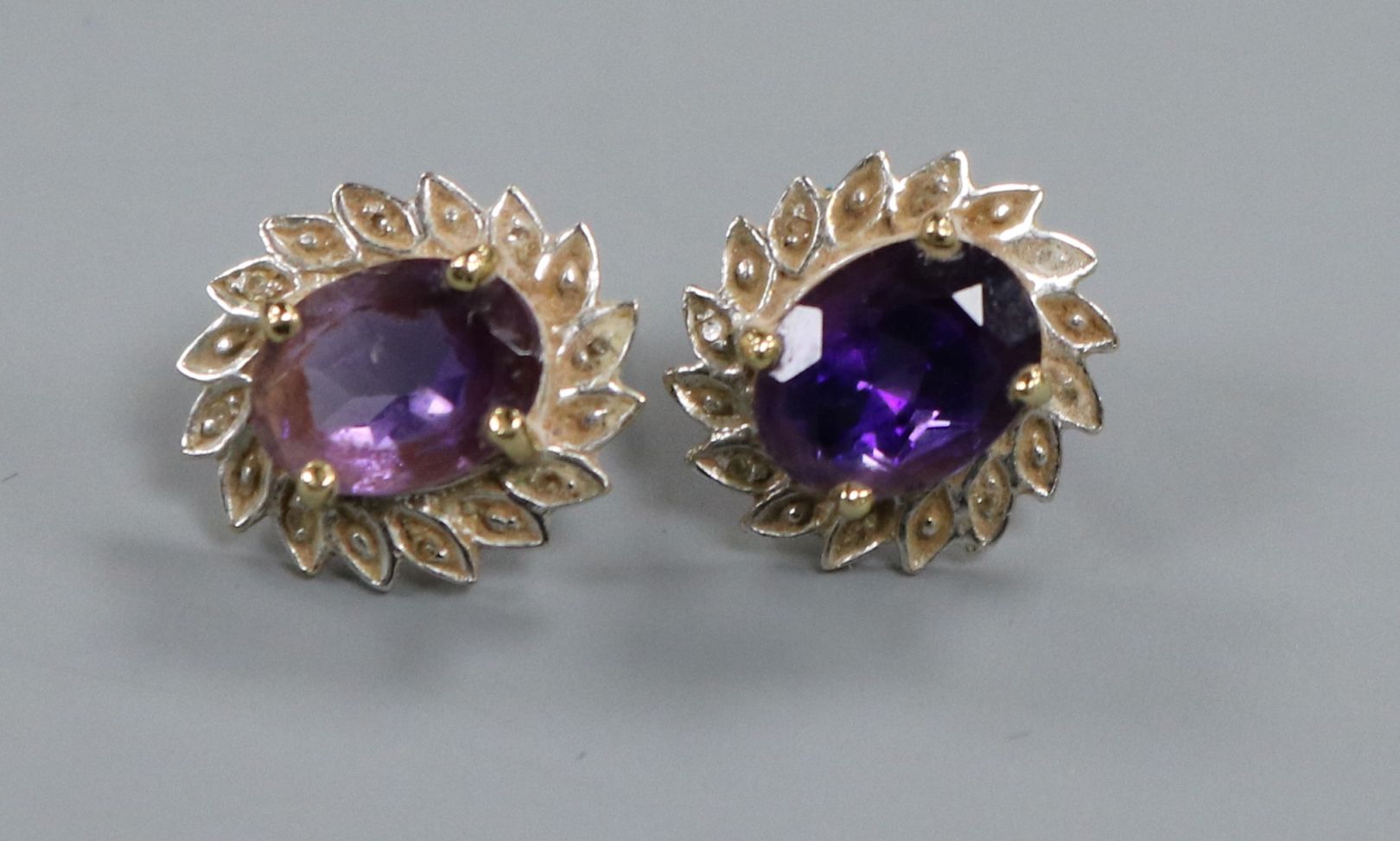 A pair of 9ct gold and oval amethyst ear studs.