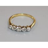 An 18ct gold and graduated five stone diamond half hoop ring, size M.