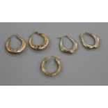 Two pairs of 9ct gold loop earrings and one odd 9ct gold earring.