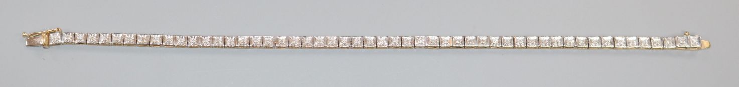 A modern 9ct gold and diamond set line bracelet, 19cm.