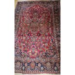 A Persian red ground rug 202 x 135cm